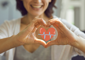Women making a heart with her hands.