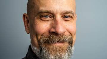 Bald smiling man with a beard