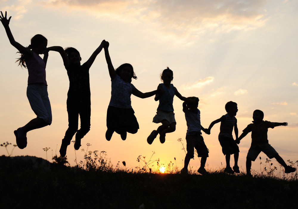 Silhouette of playing children at sunset.