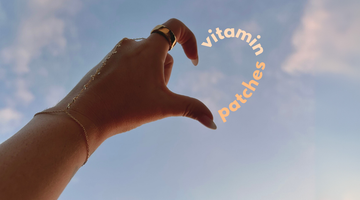 Hand heart shape with “vitamin patches” text in the sky.