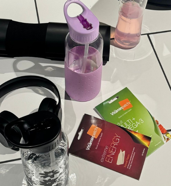 Workout essentials with water bottles, headphones, and Vitamin Patch products for energy and omega-3 support.