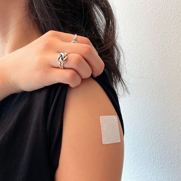 A close up of a patch on a woman's upper arm