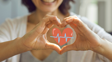 Women making a heart with her hands.