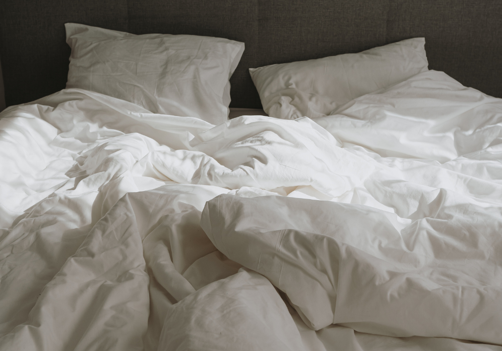 Cozy white bedding on a bed.