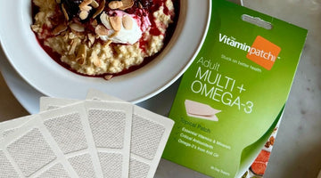 A bowl of oatmeal with toppings next to vitamin patches.